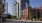 a street with tall building and people walking around them